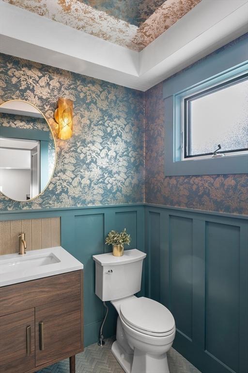 34 Walker St, Somerville, MA 02144 - bathroom with toilet, vanity, a wainscoted wall, and a decorative wall