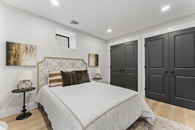 34 Walker St, Somerville, MA 02144 - bedroom with two closets, wood finished floors, recessed lighting, and baseboards