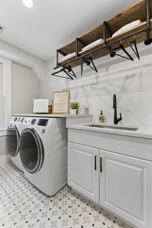 34 Walker St, Somerville, MA 02144 - laundry area featuring independent washer and dryer, cabinet space, and light flooring