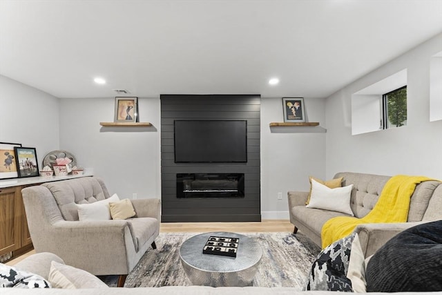 34 Walker St, Somerville, MA 02144 - living area featuring a fireplace, wood finished floors, and recessed lighting