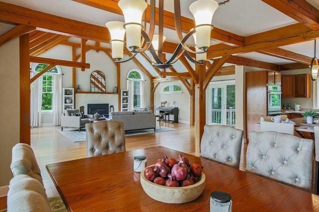 15 Allen Hill Rd, Princeton, MA 01541 - dining area with a glass covered fireplace, light wood-style flooring, baseboards, and a chandelier