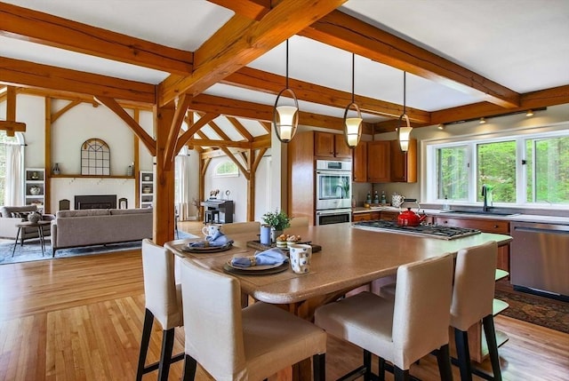 15 Allen Hill Rd, Princeton, MA 01541 - dining area with beam ceiling, light wood finished floors, and a fireplace