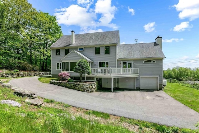 15 Allen Hill Rd, Princeton, MA 01541 - rear view of house with a chimney, driveway, a garage, a wooden deck, and a shingled roof