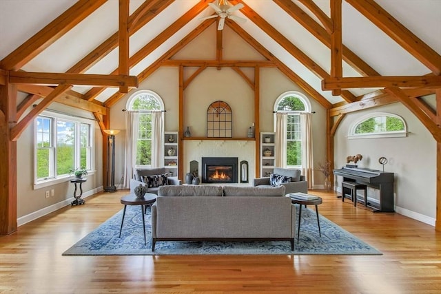 15 Allen Hill Rd, Princeton, MA 01541 - living area featuring high vaulted ceiling, healthy amount of natural light, beamed ceiling, a glass covered fireplace, and baseboards