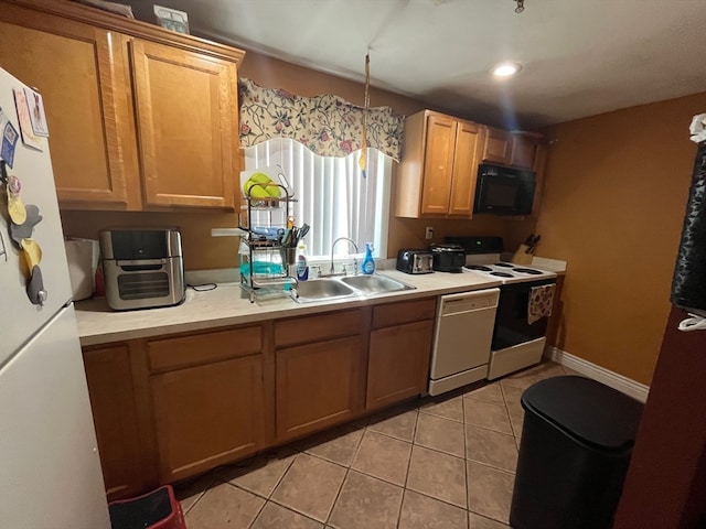 kitchen featuring light tile patterned flooring, decorative light fixtures, sink, and white appliances