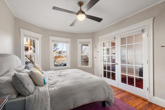 bedroom featuring ceiling fan, wood-type flooring, and french doors