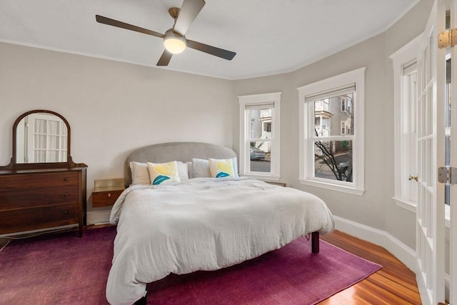 bedroom featuring ceiling fan and dark hardwood / wood-style floors