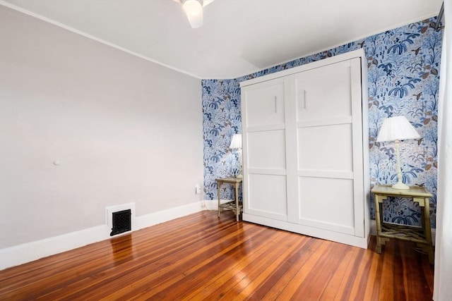 unfurnished bedroom featuring ceiling fan and wood-type flooring