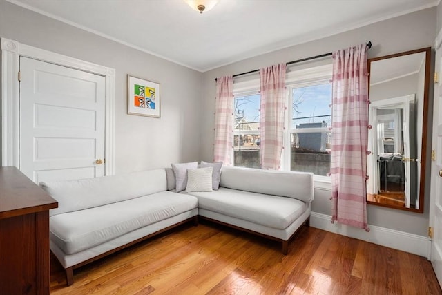 living room with hardwood / wood-style flooring and ornamental molding