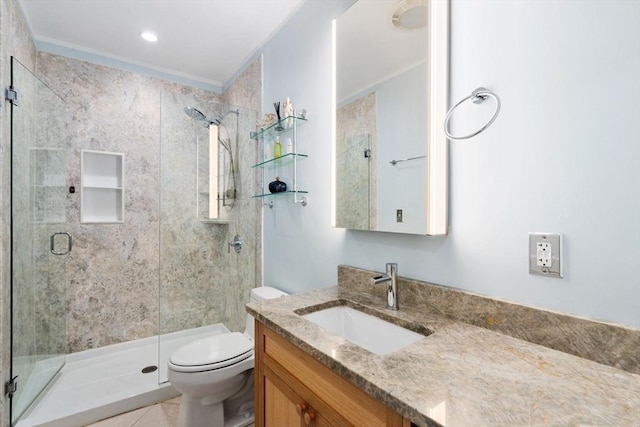 bathroom featuring toilet, a shower with door, tile patterned flooring, ornamental molding, and vanity