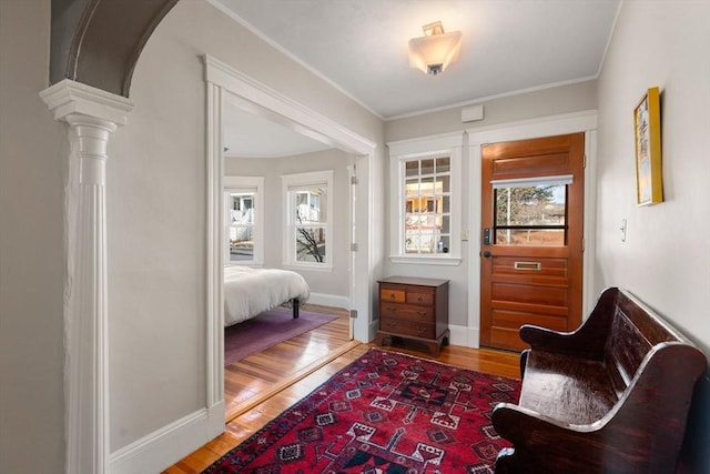 bedroom with hardwood / wood-style floors and ornamental molding