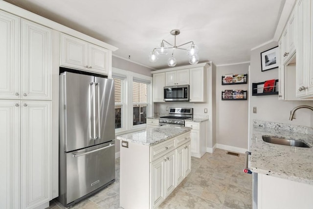 kitchen with pendant lighting, a kitchen island, stainless steel appliances, sink, and crown molding