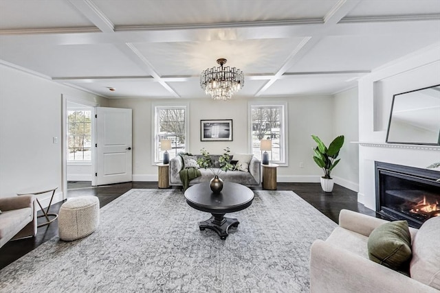 living room with dark wood-style flooring, coffered ceiling, a glass covered fireplace, and baseboards