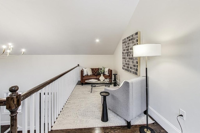 living area with lofted ceiling and baseboards