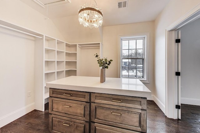 walk in closet featuring attic access, visible vents, and dark wood finished floors