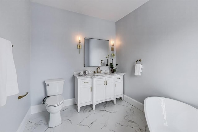 bathroom featuring marble finish floor, vanity, and baseboards