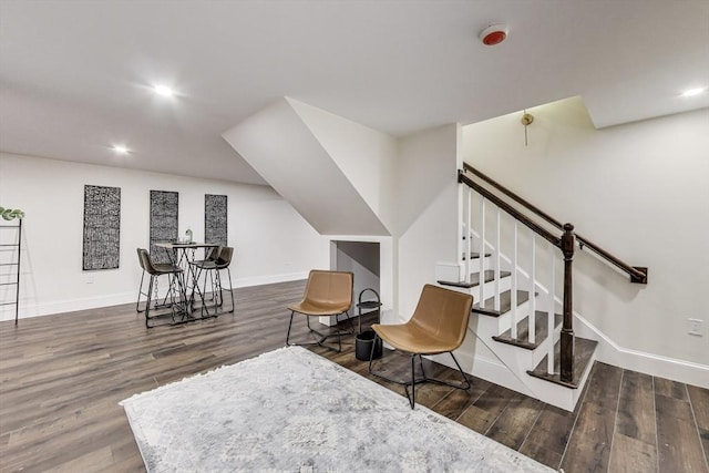 sitting room with stairway, baseboards, dark wood finished floors, and recessed lighting