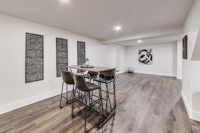 dining room with recessed lighting, baseboards, and wood finished floors