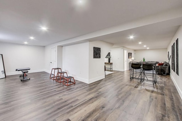 interior space with dark wood-type flooring, recessed lighting, and baseboards