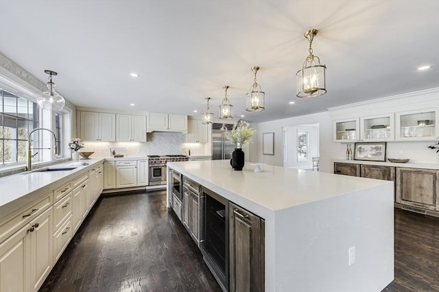 kitchen with a spacious island, light countertops, glass insert cabinets, and white cabinetry