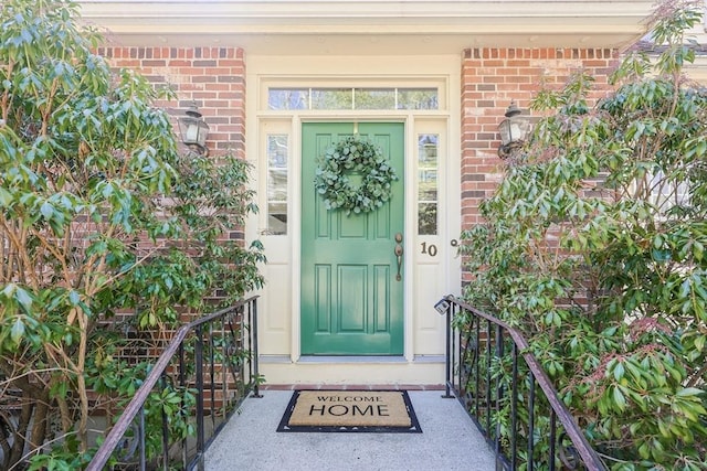 doorway to property with brick siding