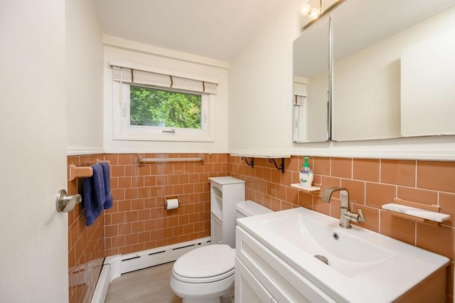 13 Smith Rd, Hingham, MA 02043 - bathroom with a baseboard heating unit, vanity, toilet, tile walls, and wainscoting