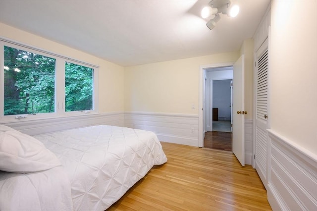 13 Smith Rd, Hingham, MA 02043 - bedroom with light wood finished floors and a wainscoted wall