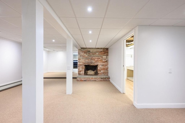 13 Smith Rd, Hingham, MA 02043 - finished basement with carpet, a paneled ceiling, a baseboard radiator, a fireplace, and baseboards