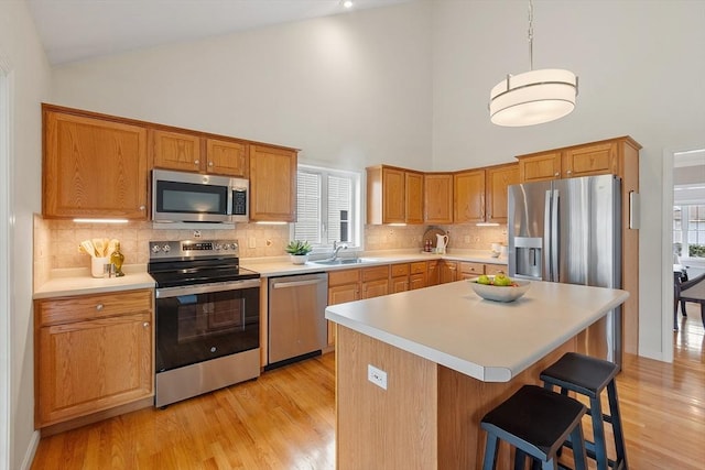 45 Augusta Way Unit 23, Chelmsford, MA 01863 - kitchen featuring stainless steel appliances, a sink, high vaulted ceiling, light wood-type flooring, and light countertops