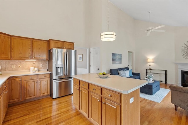 45 Augusta Way Unit 23, Chelmsford, MA 01863 - kitchen with stainless steel refrigerator with ice dispenser, open floor plan, light wood-type flooring, ceiling fan, and high vaulted ceiling