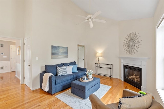 45 Augusta Way Unit 23, Chelmsford, MA 01863 - living room featuring high vaulted ceiling, light wood finished floors, a glass covered fireplace, ceiling fan, and baseboards