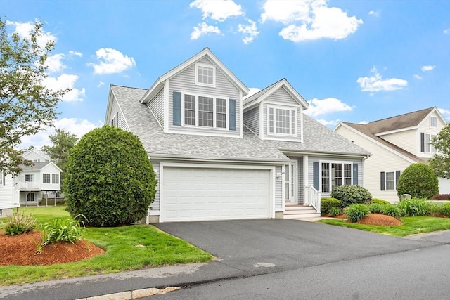 45 Augusta Way Unit 23, Chelmsford, MA 01863 - view of front facade featuring roof with shingles, asphalt driveway, a garage, and a front yard