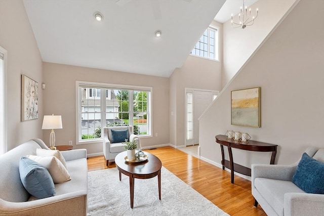 45 Augusta Way Unit 23, Chelmsford, MA 01863 - living area with healthy amount of natural light, a chandelier, high vaulted ceiling, and light wood-style flooring