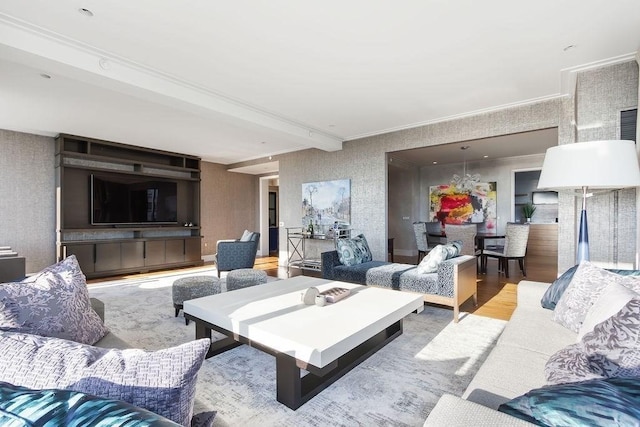 living area featuring crown molding, wallpapered walls, and wood finished floors