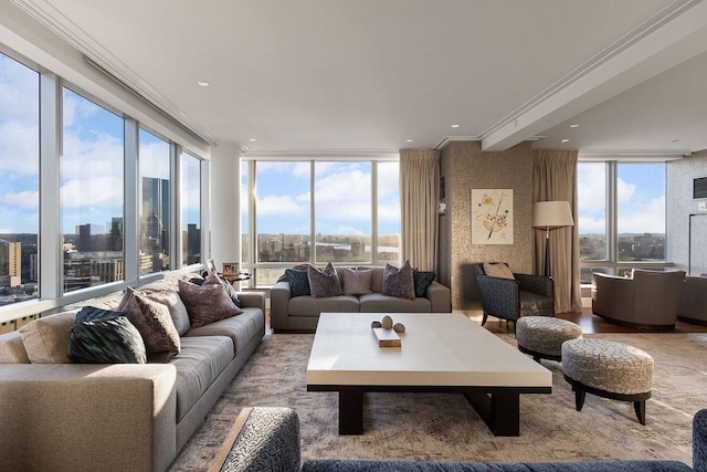 living room featuring healthy amount of natural light, crown molding, and floor to ceiling windows