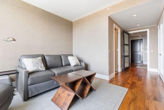 living room with crown molding, wood finished floors, and baseboards