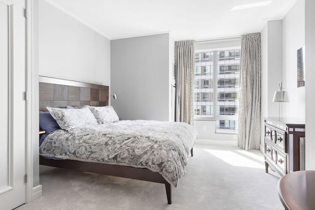 carpeted bedroom featuring crown molding and baseboards