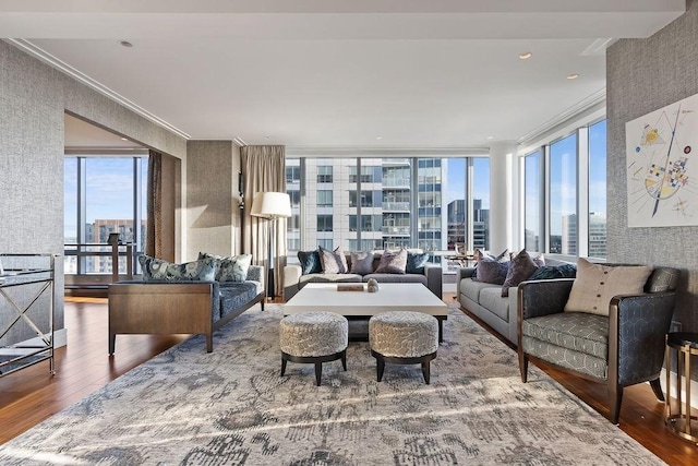 living area featuring wood-type flooring, a view of city, and ornamental molding