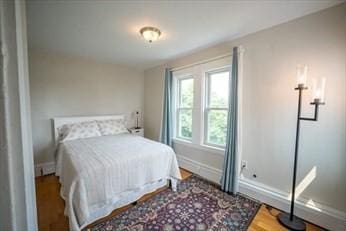 bedroom with baseboards and wood finished floors