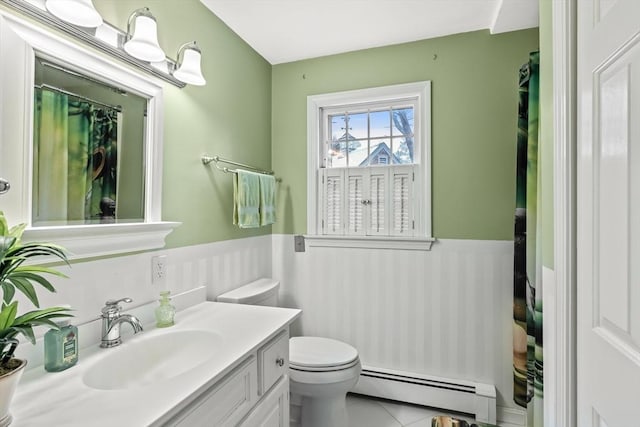 full bath featuring wainscoting, toilet, a baseboard radiator, tile patterned floors, and vanity