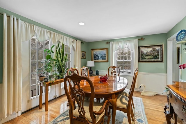 dining area featuring light wood-type flooring and plenty of natural light