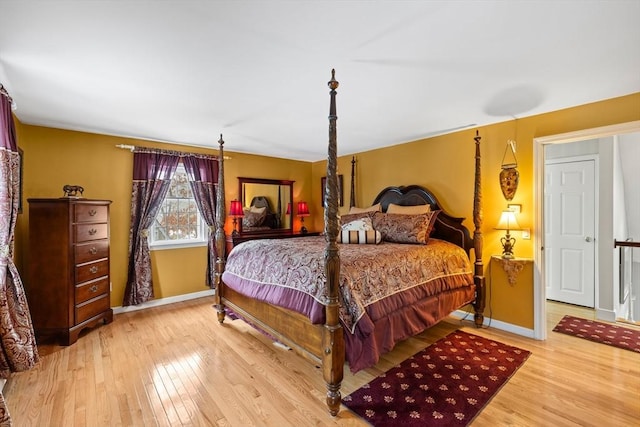 bedroom featuring baseboards and wood finished floors