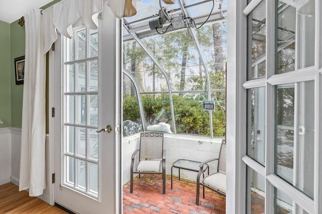 entryway featuring brick floor and a sunroom