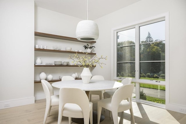 dining space featuring light wood-type flooring