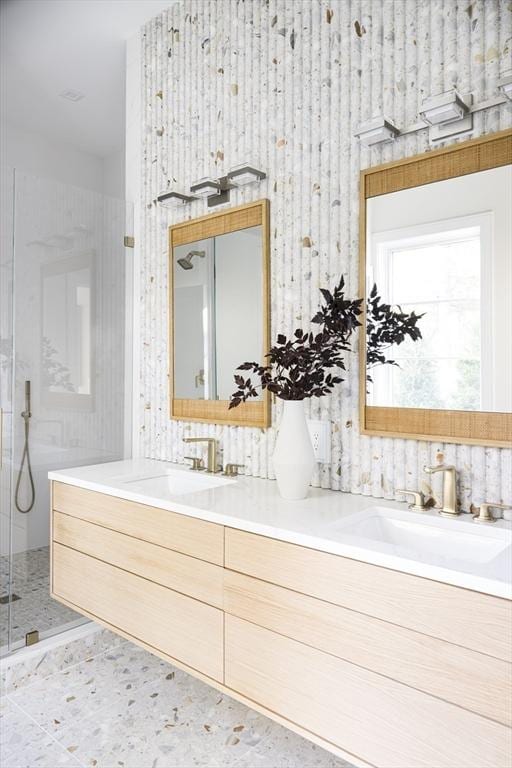 bathroom with vanity and a shower