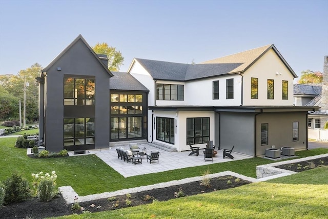 back of house featuring an outdoor fire pit, central air condition unit, a patio area, and a lawn