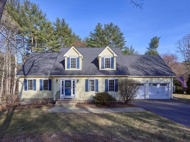 cape cod house with driveway, a front lawn, a garage, and a shingled roof