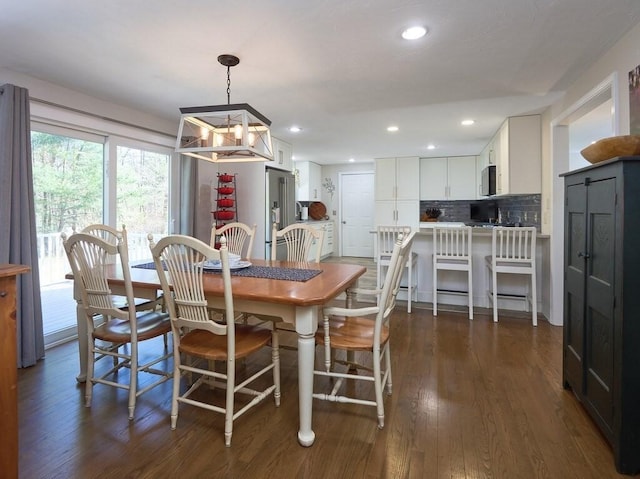 dining space with dark wood-style floors and recessed lighting