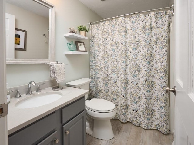 full bath with a shower with curtain, toilet, wood finished floors, and vanity