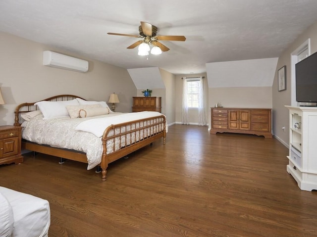 bedroom with wood finished floors, a wall unit AC, baseboards, ceiling fan, and vaulted ceiling